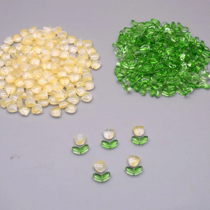 A collection of yellow and green glass beads, including loose beads and small clusters.