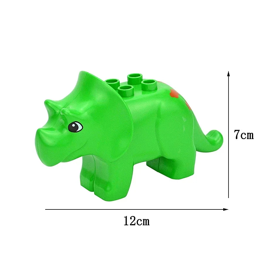 A green dinosaur-shaped building block toy with a small eye and a red detail, shown from the side.