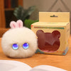 A fluffy white rabbit plush toy with pink ears is displayed next to its cardboard packaging.