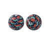 A pair of black silicone beads printed with an orange and white pattern featuring the words Honey and Howdy