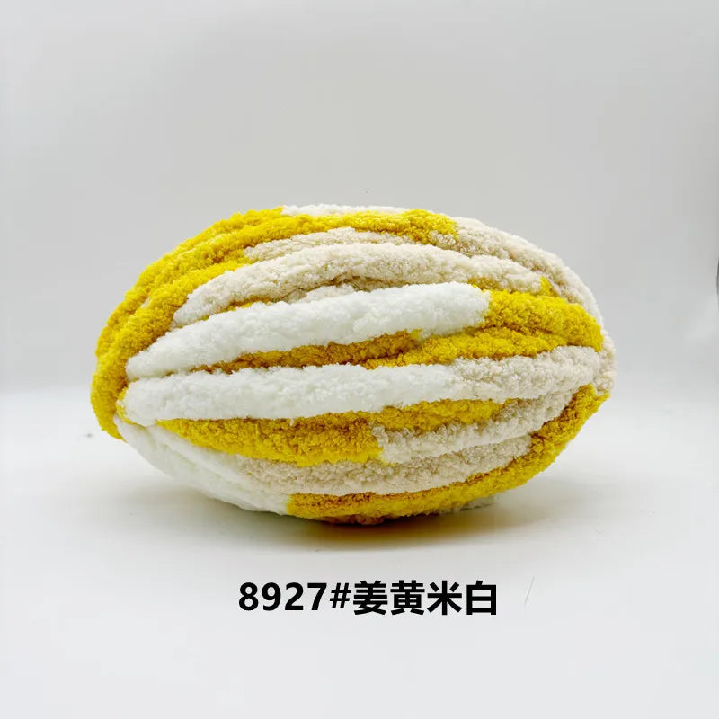 A ball of chunky chenille yarn featuring alternating stripes of bright yellow and white.