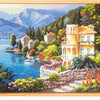 Diamond painting of a scenic landscape featuring a large house, mountains, and blue water.