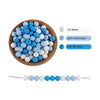 A collection of round silicone beads in white, pastel blue, and sky blue colors for jewelry making.