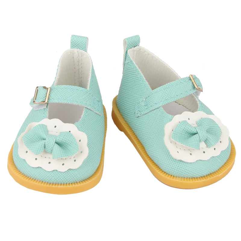 A pair of light blue unicorn skirt outfits for 18-inch dolls featuring white fabric and pink accents.