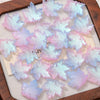 A collection of pink and blue maple leaf glass beads for DIY jewelry making