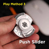 A hand holds a silver magnetic fidget spinner with push sliders, demonstrating Play Method 3.