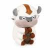 A soft plush doll resembling a stylized bison or horned creature with white, gray, and brown fur patches.