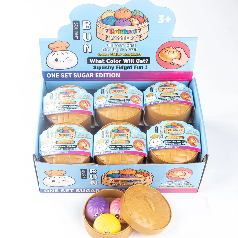 Eine Box mit farbenfrohen Fidget-Dumpling-Spielzeugen und einem rosa und gelben Silikon-Fidget-Werkzeug.