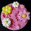 Pink silicone mold with various colored 3D flowers for decorating fondant, cake, and chocolate