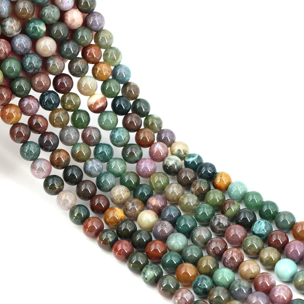 A string of round, loose natural India agate beads in various shades of green, brown, and purple.