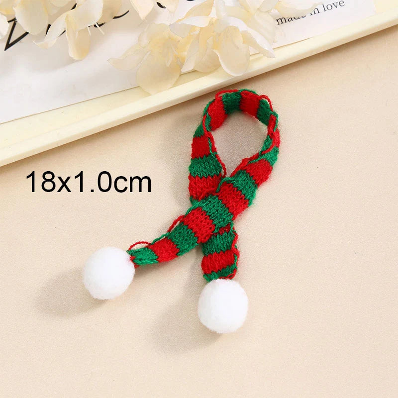 A set of mini knit Christmas hats and scarves in red and green with white pom-poms.