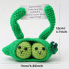 Handmade crochet green alien with a pocket and a sign encouraging confidence