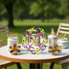 Colorful expandable magic ball stress relief toy with various neon colors resting on a table outdoors.