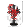 A black gothic cross structure decorated with red roses and skeleton hands, shown with dimensions.