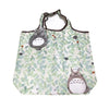 A light green patterned fabric tote bag featuring cute cartoon hippo and owl designs.