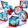 A collection of handmade polyhedral dice featuring a vibrant galaxy finish in blue, red, and purple.