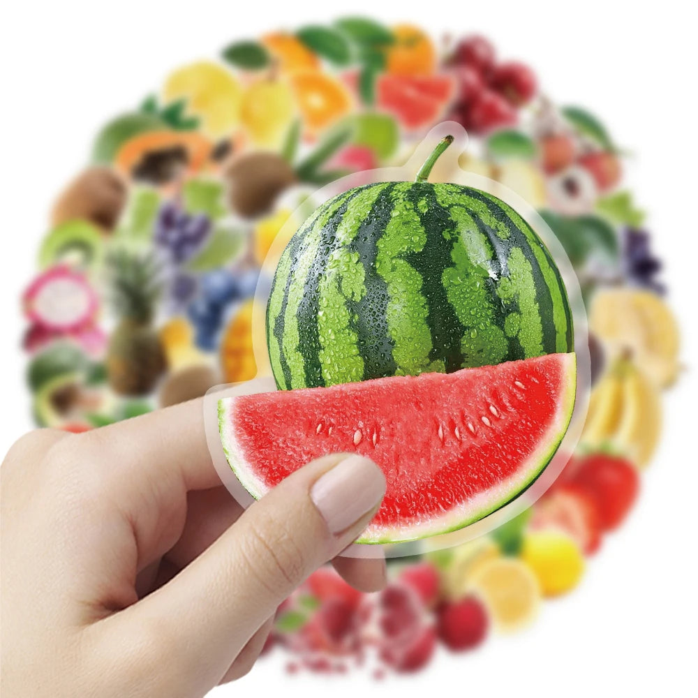 A hand holds a slice of watermelon against a background of various colorful fruit stickers.