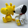 A yellow and white plush set featuring Snoopy and Woodstock characters.
