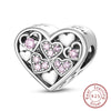A sterling silver heart pendant featuring multiple heart-shaped charms, some pink, displayed against a white background.