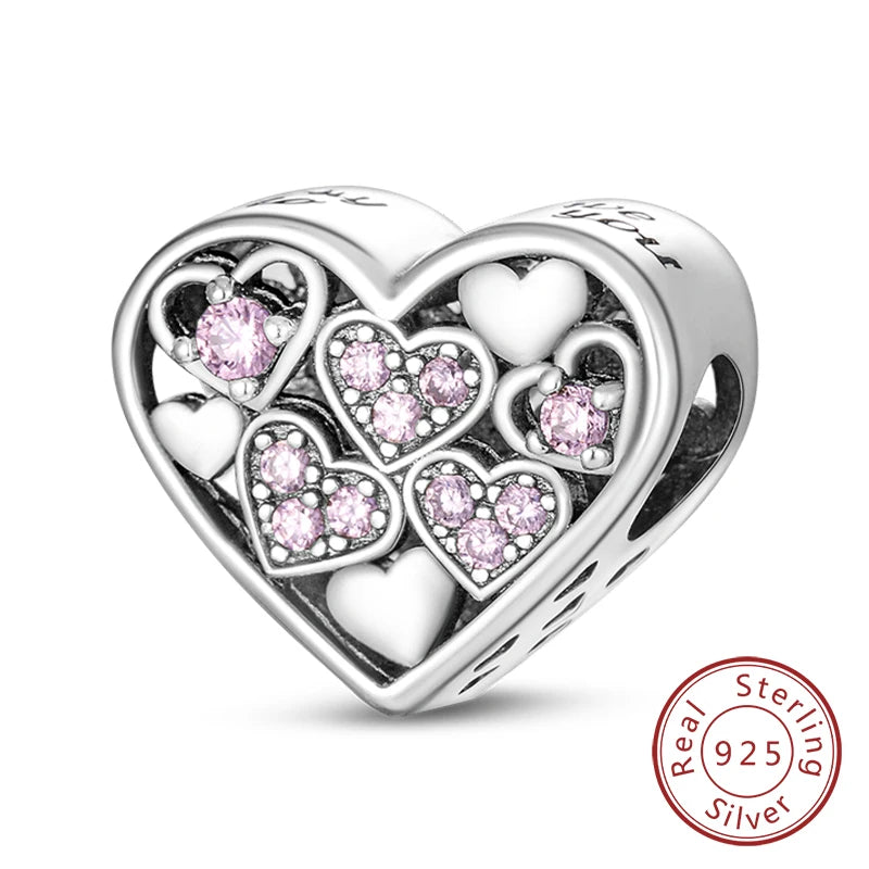 A sterling silver heart pendant featuring multiple heart-shaped charms, some pink, displayed against a white background.