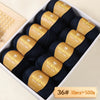 A box of 10 balls of Merino wool yarn in dark blue and gold packaging for knitting