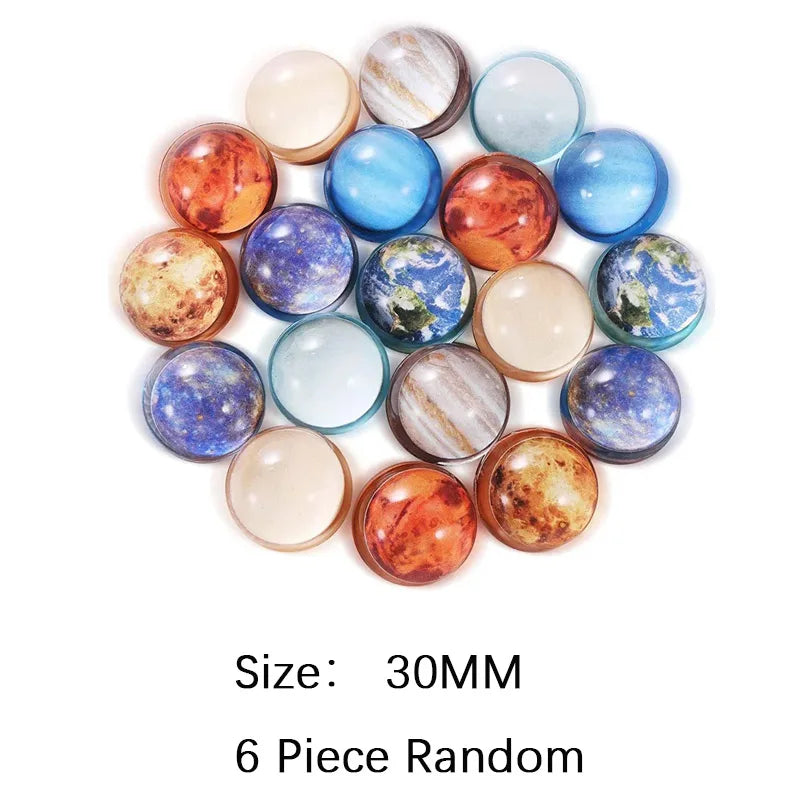 A collection of six assorted, shiny rubber bouncy balls in various shades of blue, gold, and iridescent colors.