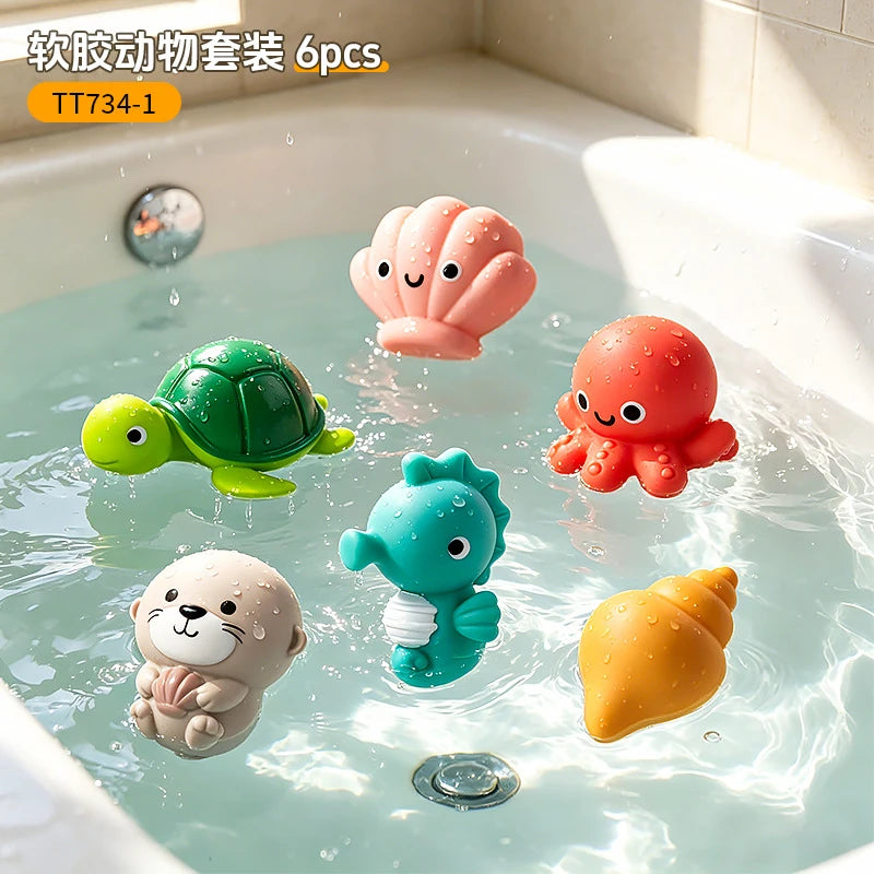Six plastic bath toys shaped like a sea turtle, clam, and other animals floating in water.