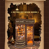 A wooden miniature kit of a magic wand shop display inside a diorama book nook.