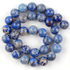 A circular arrangement of small, round beads made from natural sea sediment jasper and turquoise for jewelry making