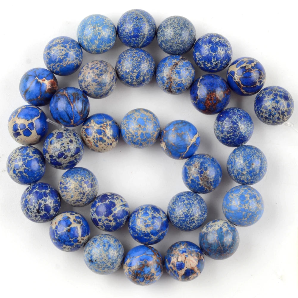 A circular arrangement of small, round beads made from natural sea sediment jasper and turquoise for jewelry making