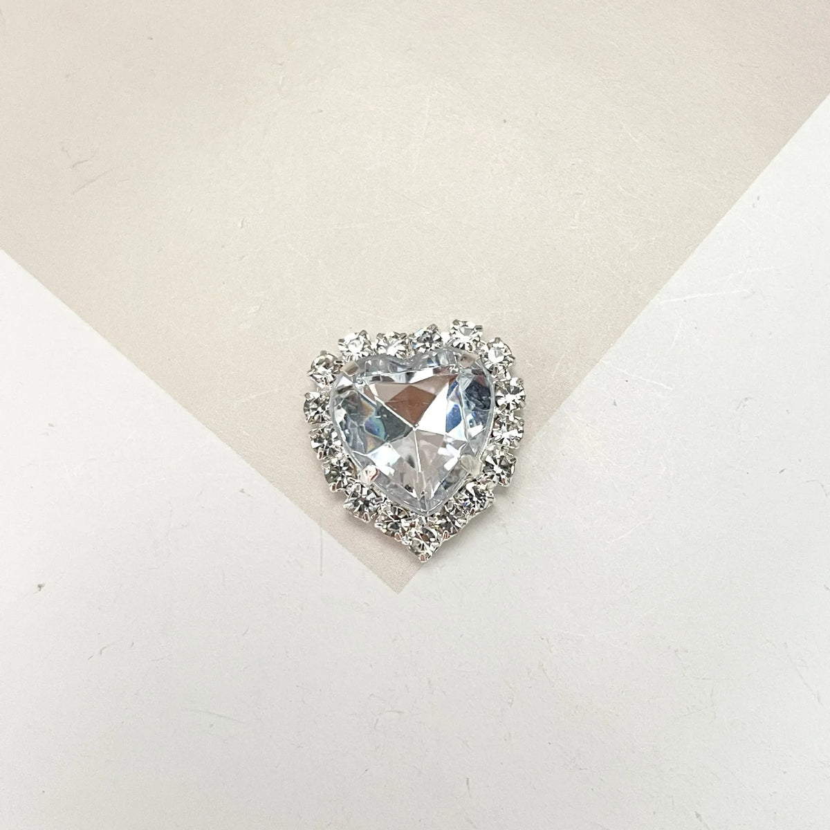 A heart-shaped flatback rhinestone embellishment for DIY crafts.