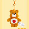 A fluffy orange Care Bears plush toy attached to a gold-colored keychain ring.