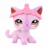 A pink miniature cat figure with a pink crown and black markings.