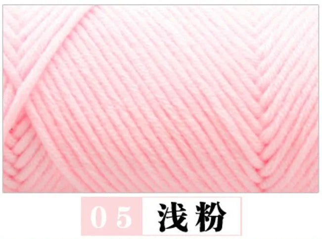 A close-up of pink milk cotton yarn being wound on a knitting machine.