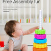 A baby is stacking colorful rings and a white tower toy for free assembly fun.