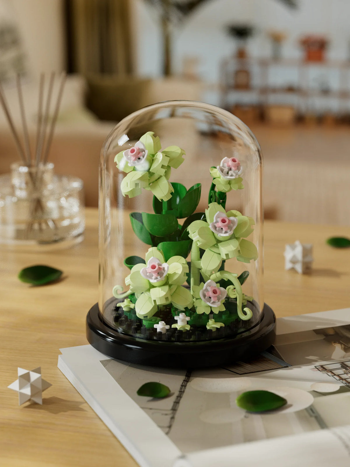 A glass dome display of a miniature green rose plant kit on a wooden table.
