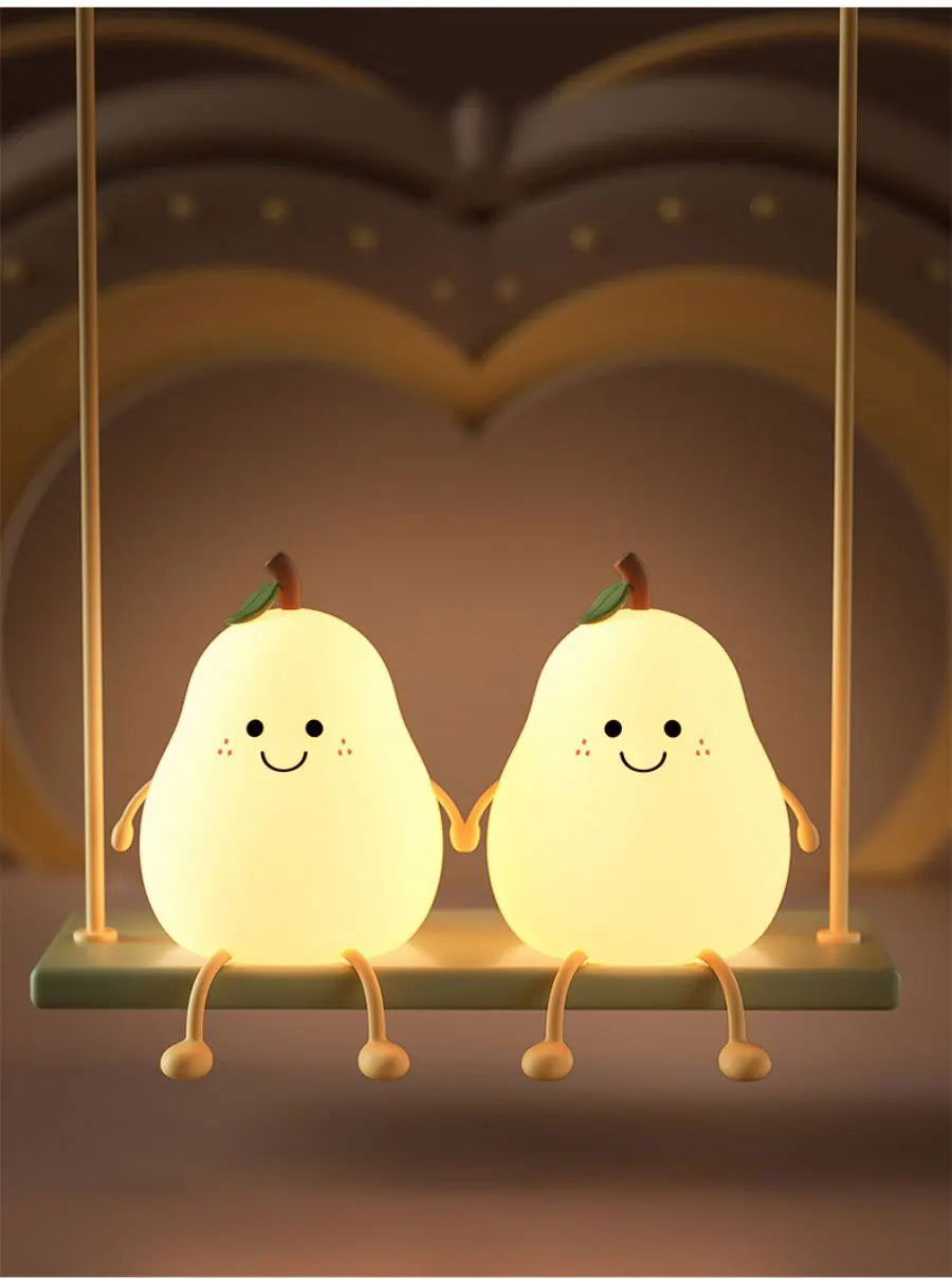 A pair of glowing pear-shaped night lights hanging from a fixture.