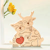 A wooden puzzle decoration featuring three elk figures with names Emma, Olivia, and William.
