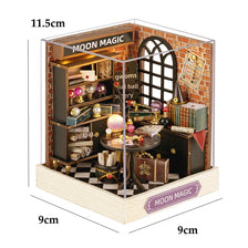 A miniature dollhouse kit of a seaside beach house with an arched window and interior details.