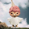 A small mischievous figure with pink hair and a gold conical hat stands on a grassy surface.