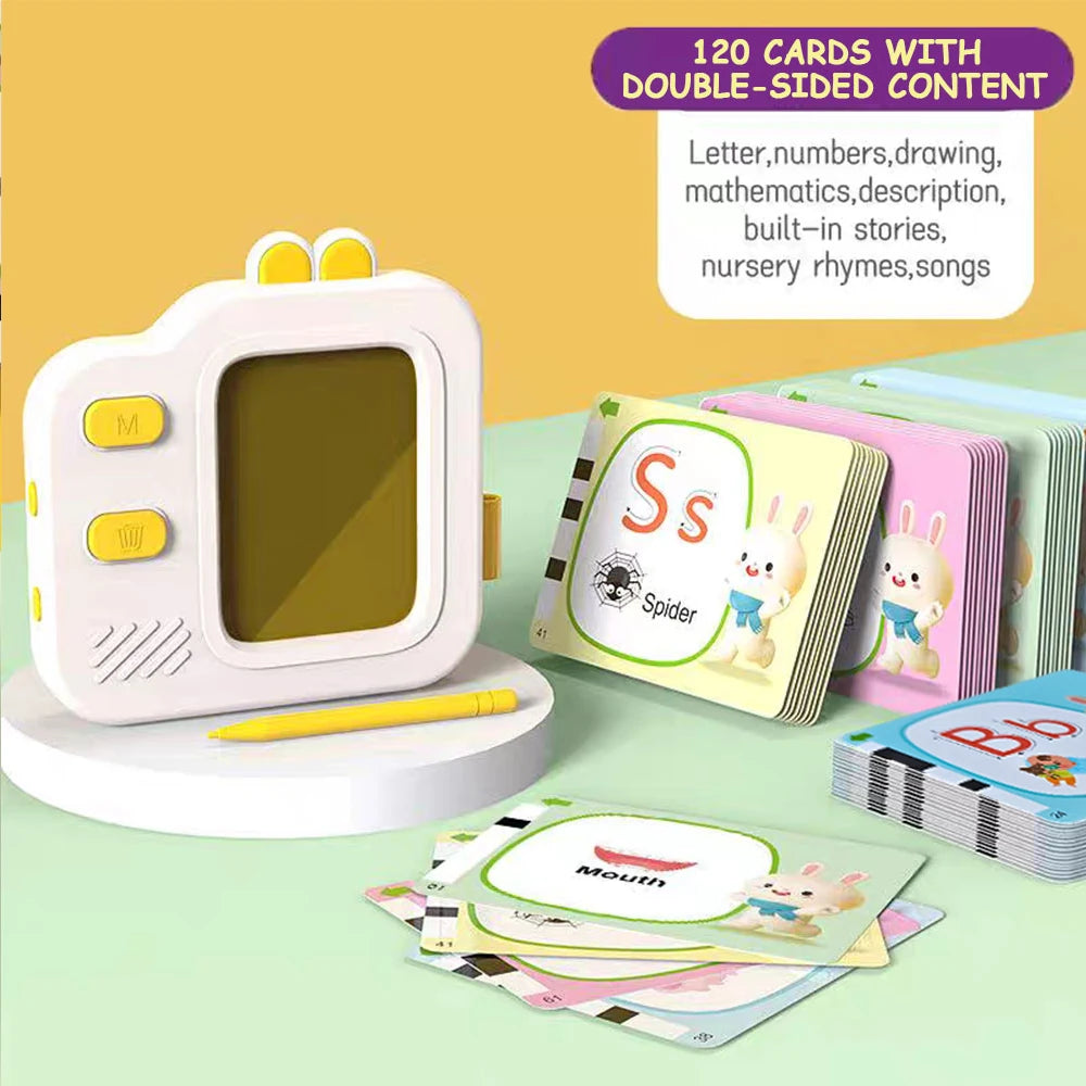 A pink camera toy is shown next to a stack of learning flash cards featuring letters and drawings.