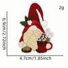 A red cartoon character patch resembling a Santa hat and face, embroidered in red and beige thread.
