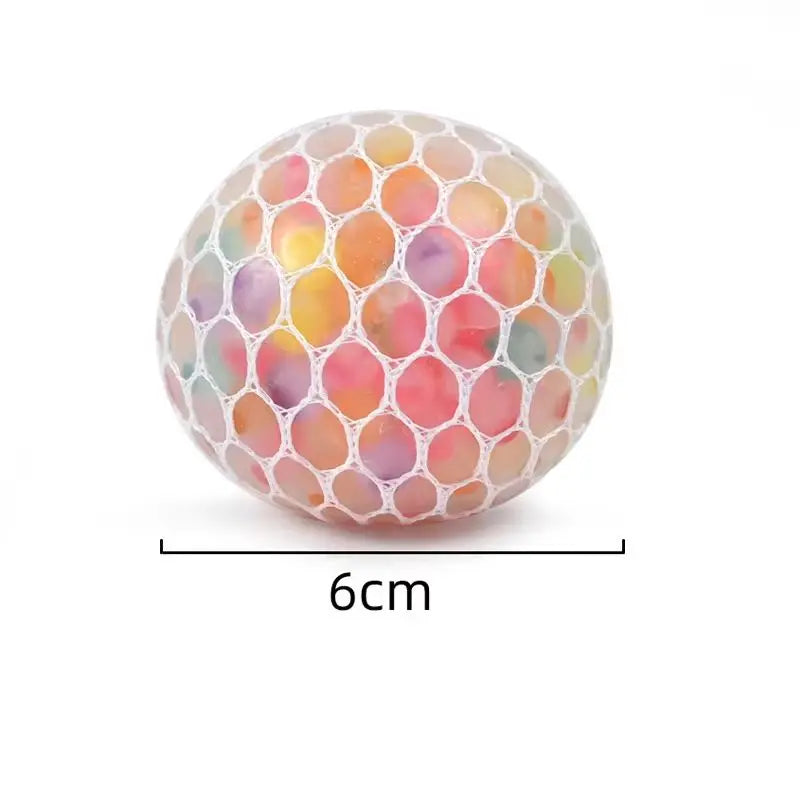 A spherical squishy stress relief ball with a translucent, multicolored, honeycomb-like texture.