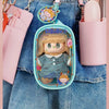A pink LABUBU doll bag pendant keychain featuring a character with blonde hair and a blue outfit attached to a denim shirt.