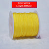 Yellow nylon knotting cord for jewelry making, 50 meters long and wound on a spool.