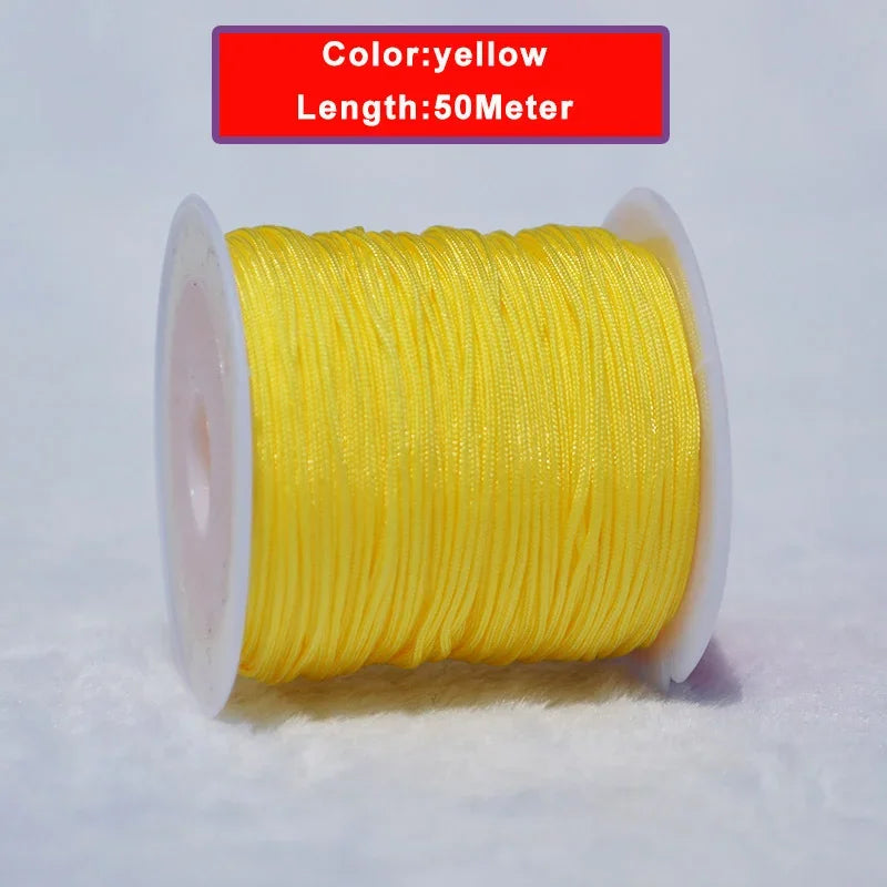 Yellow nylon knotting cord for jewelry making, 50 meters long and wound on a spool.