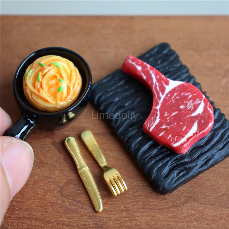 A miniature dollhouse set featuring a red steak and pasta food item served on a black textured plate with small gold cutlery.