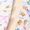 A close-up of three soft cotton baby bibs with adjustable closures in pastel colors and patterns.