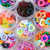 Assortment of colorful wave-patterned acrylic beads in various shades and shapes for jewelry making