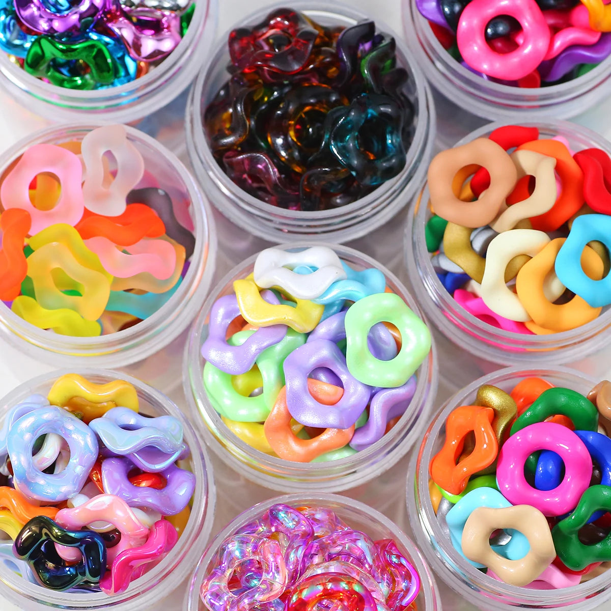 Assortment of colorful wave-patterned acrylic beads in various shades and shapes for jewelry making